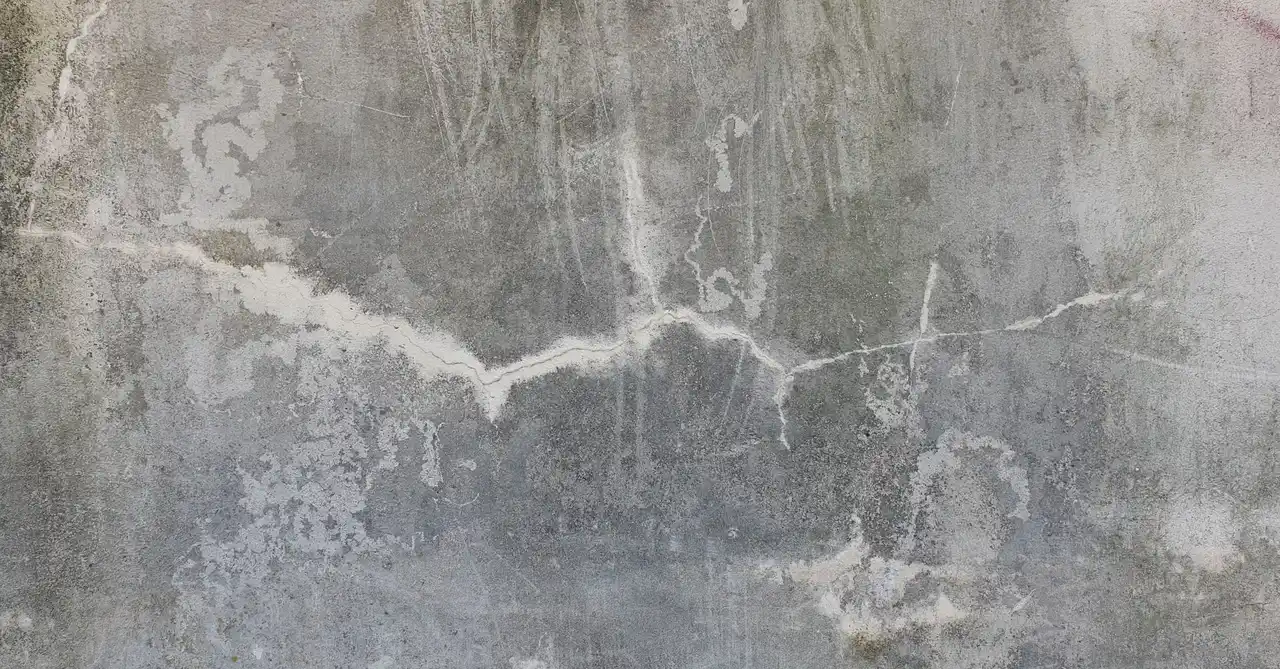 High-resolution image of a weathered and cracked concrete wall, perfect for texture background uses